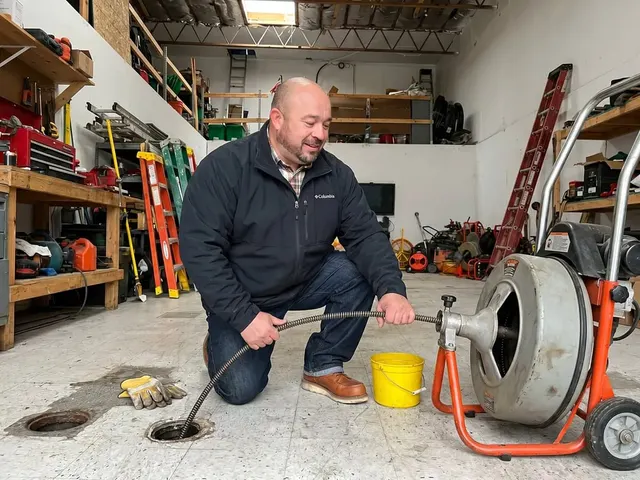 Alfredo Ortiz running a drain-cleaning machine at a cleanout in Livermore